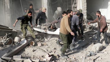  Syrians evacuate a wounded man on a stretcher following a reported airstrike by Syrian government forces in Damascus' rebel-held suburb of Zamalka, on January 6, 2016. afp