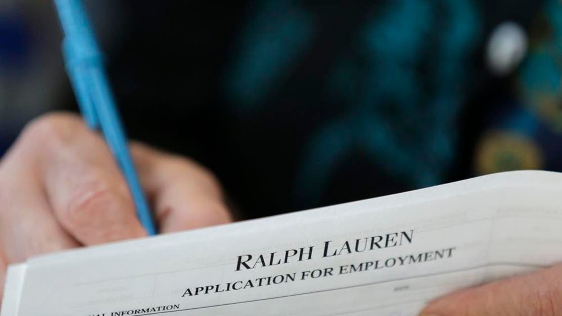 In this Tuesday, Oct. 6, 2015 photo, a job seeker fills out a job application during a job fair at Dolphin Mall in Miami. The Labor Department reports on the number of people who applied for unemployment benefits during the week ending Oct. 24 on Thursday, Oct. 29, 2015. (AP Photo/Wilfredo Lee)