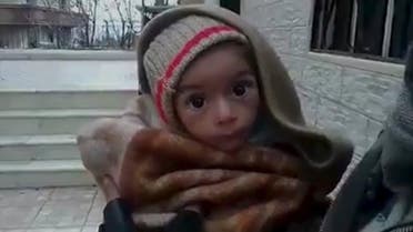 A toddler is held up to the camera in this still image taken from video said to be shot in Madaya on January 5, 2016. (Reuters)