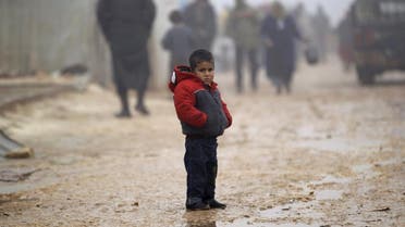 A boy stands outside tents housing internally displaced people, during the cold weather in Jerjnaz camp, in Idlib province, Syria. (File photo: Reuters) 