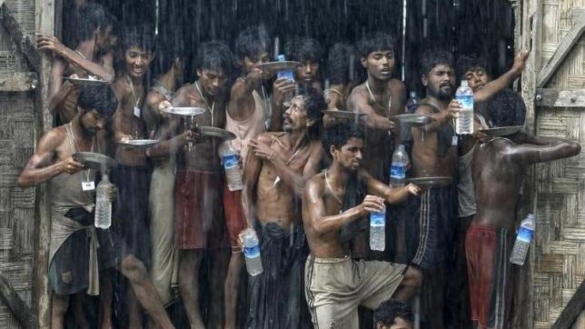 Migrants, who were found at sea on a boat, collect rainwater during a heavy rain fall at a temporary refugee camp near Kanyin Chaung jetty, outside Maungdaw township, northern Rakhine state, Myanmar June 4, 2015. (Reuters)
