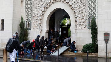  Muslims pray by the entrance of the Great Mosque of Paris during the Friday priest, in Paris, France, Friday, Nov. 20, 2015 one week after the Paris attacks. France called Friday on its European Union partners to take immediate and decisive action to toughen the bloc's borders and prevent the entry of more violent extremists. (AP Photo/Francois Mori)