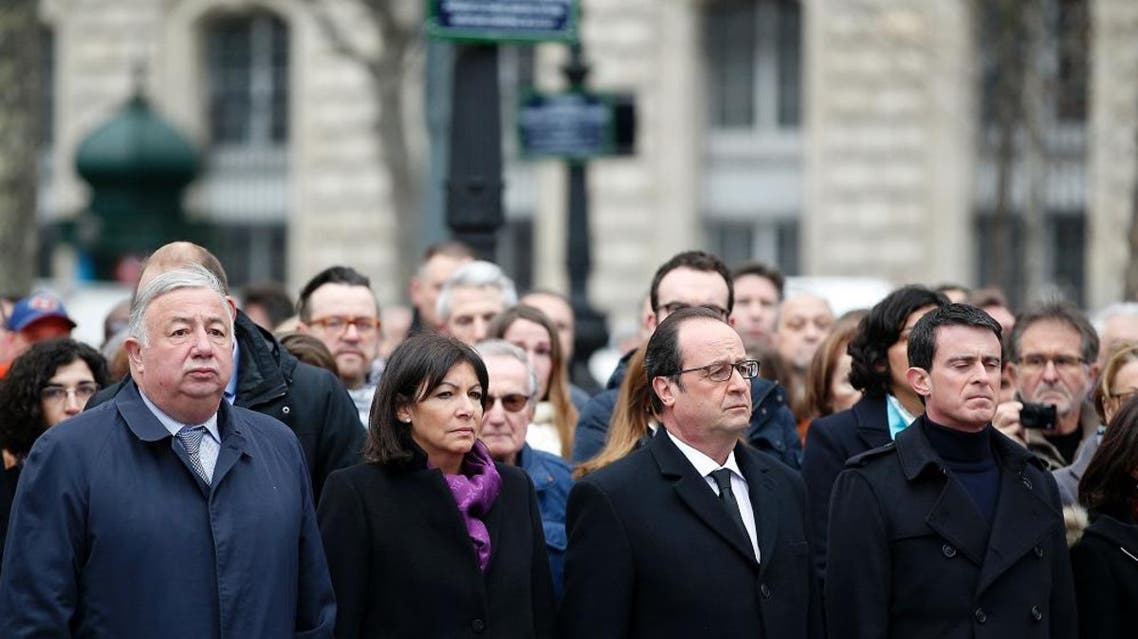 (From L) President of the French Senate Gerard Larcher, French Paris' mayor Anne Hidalgo, French President Francois Hollande and French Prime minister Manuel Valls attend a remembrance rally attended by the President of France at Place de la Republique (Republic square) on January 10, 2016 to mark a year since 1.6 million people thronged the French capital in a show of unity after attacks on the Charlie Hebdo newspaper and a Jewish supermarket. Just as it was last year, the vast Place de la Republique will be the focus of the gathering as people reiterate their support for freedom of expression and remember the other victims of what would become a year of jihadist outrages in France, culminating in the November 13 coordinated shootings and suicide bombings that killed 130 people and were claimed by the Islamic State (IS) group. / AFP / POOL / YOAN VALAT