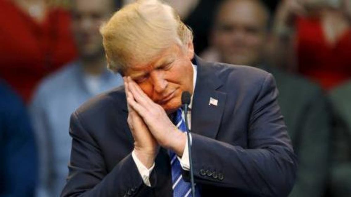 Republican presidential candidate Donald Trump gestures as if he is sleeping while talking about his opponent Jeb Bush during a Trump for President campaign rally in Raleigh, North Carolina December 4, 2015. (Reuters)