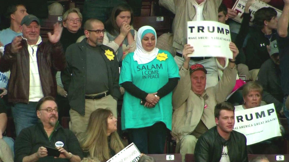 Rose Hamid, a 56-year-old flight attendant from North Carolina, stood up silently in the stands directly behind Trump. (Photo courtesy: CNN screenshot)