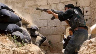 A Jaysh al-Islam (Army of Islam) rebel fighter fires his weapon towards forces loyal to Syria's President Bashar Al-Assad at the Tal-Kurdi frontline in the Eastern Ghouta of Damascus, May 10, 2015. (Reuters)