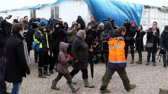 Migrants in squalid camps in France get housing upgrade