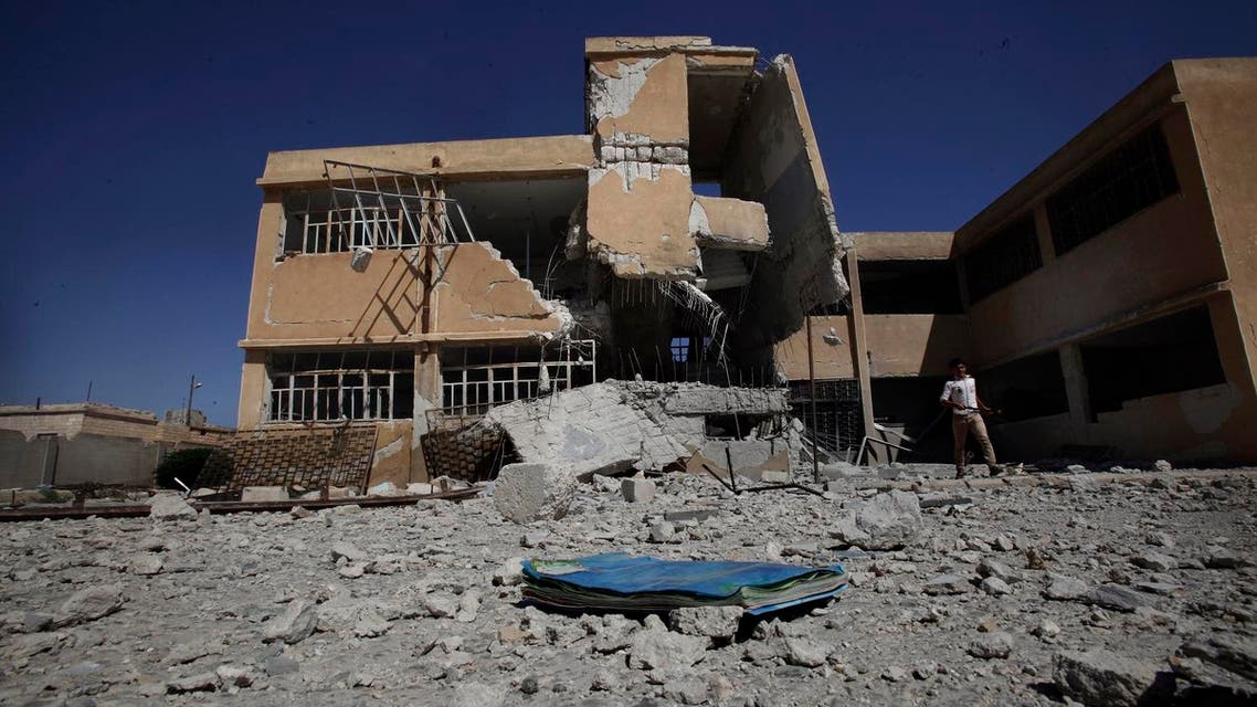 A book is left on the ground at the yard of a school destroyed in government airstrike in Tel Rifaat, on the outskirts of Aleppo, Syria, Sunday, Sept. 16, 2012. AP