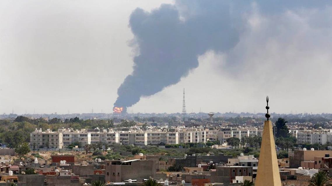 Black smoke billows over the skyline as a fire at the oil depot for the airport rages out of control after being struck in the crossfire of warring militias battling for control of the airfield, in Tripoli, Libya Monday, July 28, 2014. The latest violence to plague the country has so far killed scores of people and wounded hundreds as foreigners flee the chaos. Libya's interim government said in a statement that the fire could trigger a "humanitarian and environmental disaster" in Tripoli, appealing for "international help" to extinguish the inferno. (AP Photo/Mohammed Ben Khalifa)