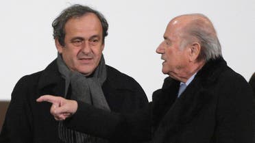In this Dec. 16, 2014 file photo FIFA president Sepp Blatter, right, and UEFA president Michel Platini talk before the semi final soccer match between Real Madrid and Cruz Azul at the Club World Cup soccer tournament in Marrakech, Morocco. AP