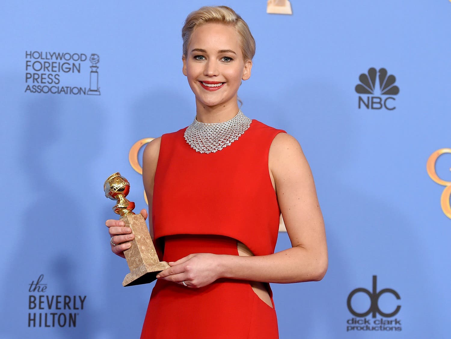 Jennifer Lawrence poses in the press room with the award for best performance by an actress in a motion picture - musical or comedy for “Joy” at the 73rd annual Golden Globe Awards. (AP)