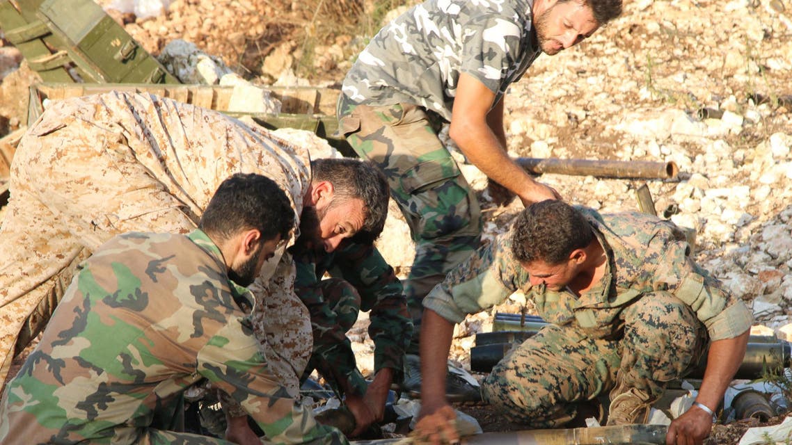In this photo taken on Saturday, Oct. 10, 2015, Syrian army personnel prepare artillery ammunition in Latakia province, about 12 miles from the border with Turkey, Syria. (AP)