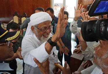 File photo of radical Islamic cleric Abu Bakar Bashir (center), waving at his supporters after his appeal hearing at the local district court in Cilacap, Central Java, Indonesia, on January 12, 2016. (AP)