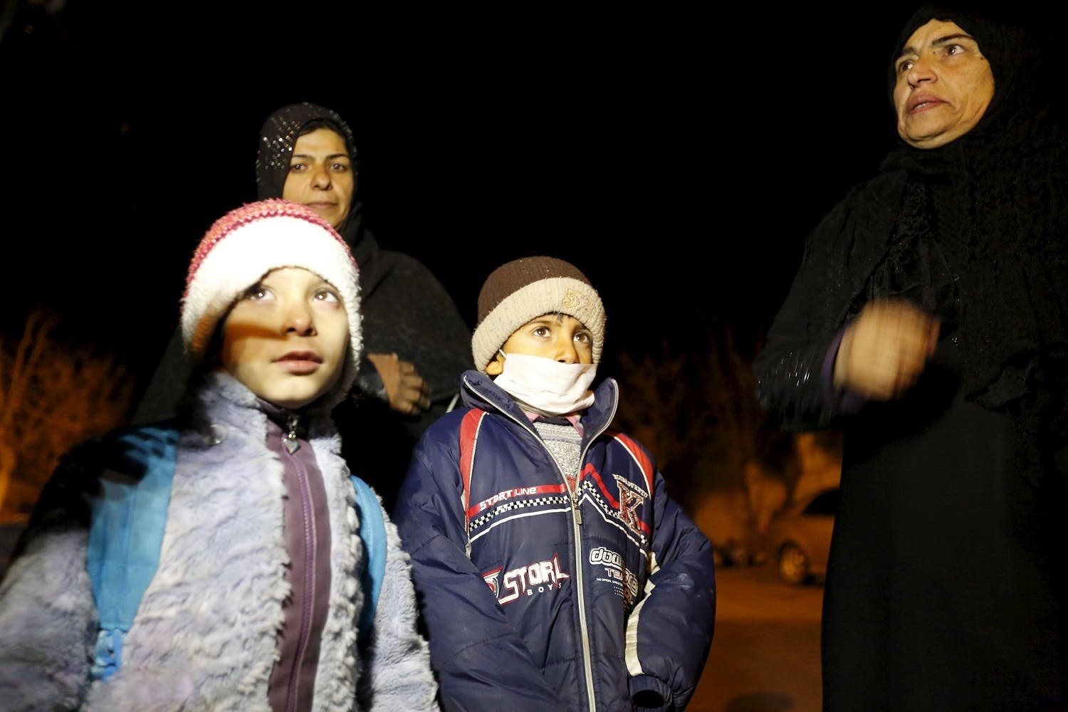 Residents who say they have received permission from the Syrian government to leave the besieged town depart after an aid convoy entered Madaya. (Reuters)