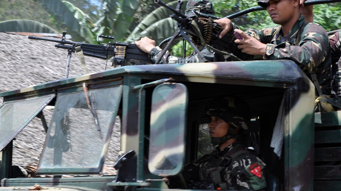 Philippine soldiers head to the mountains to secure the release of two Germans who were held for six months by the Abu Sayyaf militant group, on the volatile island of Jolo, southern Philippines, Friday, Oct. 17, 2014. Philippine Defense Secretary Voltaire Gazmin said the group released Stefan Okonek and Henrike Dielen late Friday on southern Jolo Island. (AP Photo/Nickee Butlangan)