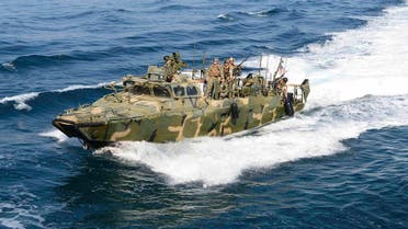 U.S. Navy handout photo of a riverine patrol boat from Costal Riverine Squadron 2 escorts the guided-missile cruiser USS Bunker Hill while in the Arabian Gulf. (Reuters)