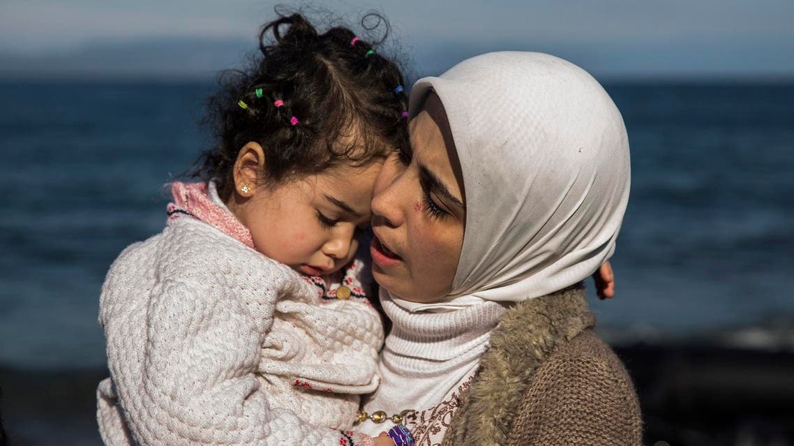A Syrian mother hugs her child after they arrived from Turkey at the Greek island of Lesbos on an overcrowded inflatable boat. (AP)
