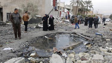 Residents gather at the site of a car bomb blast in New Baghdad, January 12, 2016.  (Reuters)