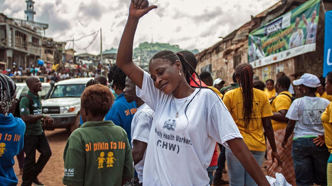 A woman celebrates with others as the country is declared Ebola free in the city of Freetown, Sierra Leone, Saturday, Nov. 7, 2015. (AP)