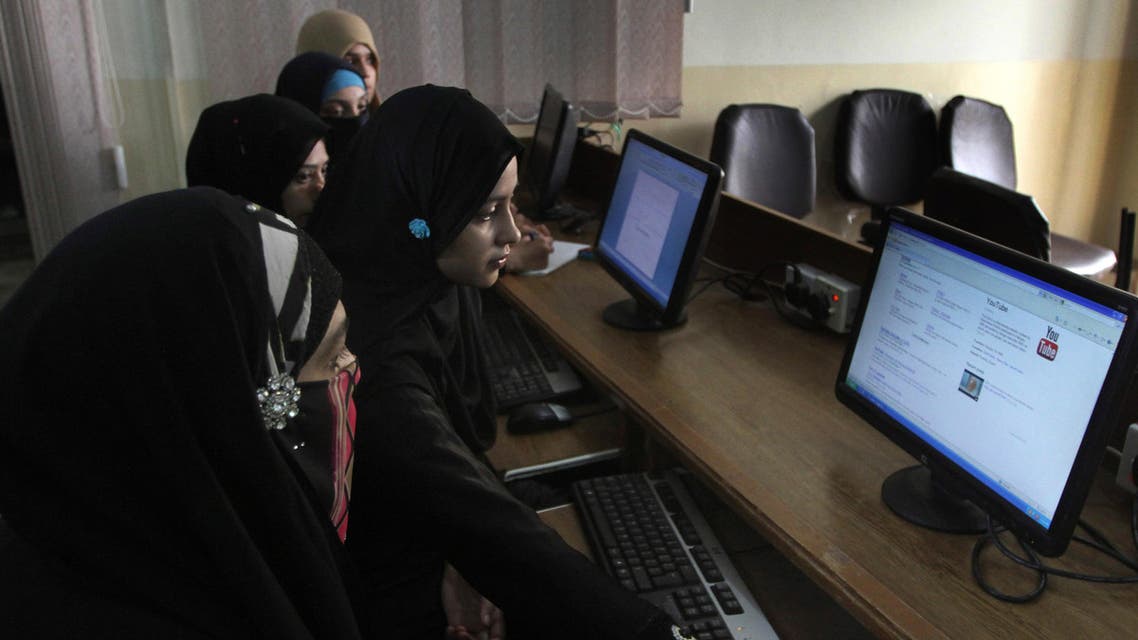 In this picture taken on Wednesday, Sept. 5, 2013, Pakistani university students try to access YouTube in Karachi, Pakistan. For almost a year, Pakistanis wanting to watch the video-sharing website YouTube have had to find other alternatives. The site has been banned since Sept. 17, 2012 after Pakistani officials acting in response outrage across the country over the airing of an anti-Islamic film blocked access to YouTube. (AP Photo/Shakil Adil)