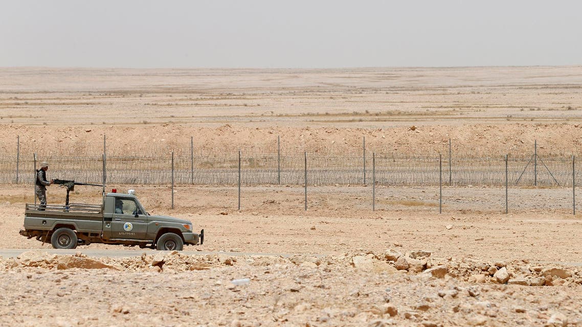 A military truck belonging to the Saudi border guards force patrol near a fence on Saudi Arabia's northern borderline with Iraq July 14, 2014. (Reuters)