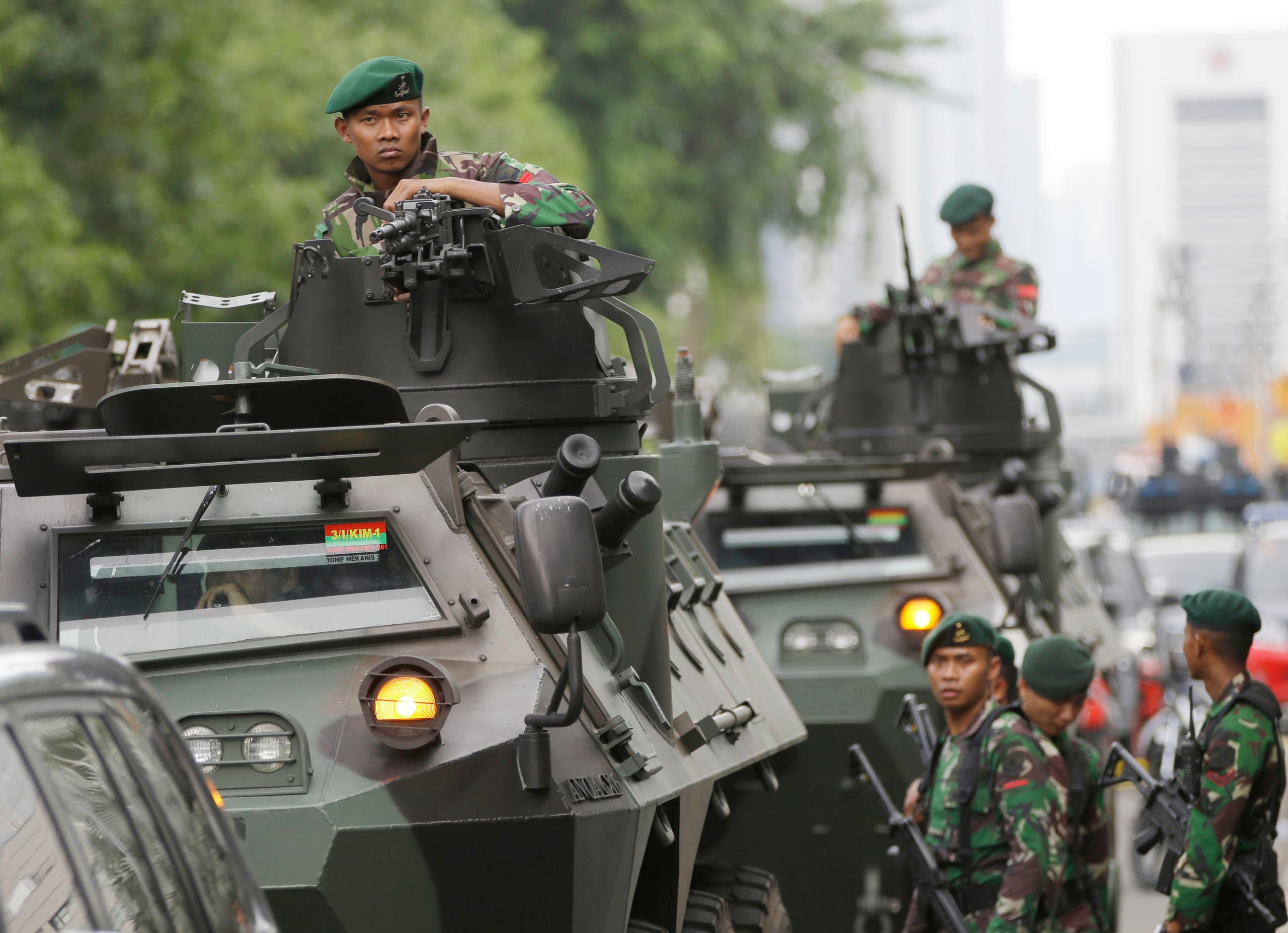  Indonesian soldiers man an armored vehicle as they guard near the site where an attack occurred in Jakarta, Indonesia Thursday, Jan. 14, 2016. Attackers set off explosions at a Starbucks cafe in a bustling shopping area in Indonesia's capital and waged gunbattles with police Thursday, leaving bodies in the streets as office workers watched in terror from high-rise windows. (AP Photo/Dita Alangkara)