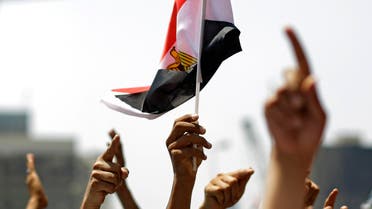  People raise hands and wave Egyptian flag during a rally after Friday prayers in Tahrir Square in Cairo, Friday, July 1, 2011. Hundreds of people were rallying in the square, that was the epicenter of the uprising that toppled Hosni Mubarak, demanding speedy trials for former regime figures and policemen accused of killing protesters during the 18-day revolt earlier this year. The rally is dubbed "Friday of Retribution" to reflect what protesters perceive as a slow pace of trials of former officials, nearly five months after Mubarak's Feb. 11 ouster.(AP Photo/Sergey Ponomarev)