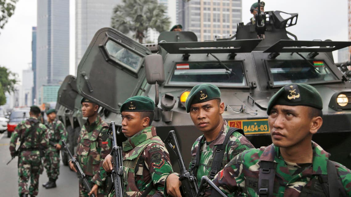  Indonesian soldiers stand guard near the site where an explosion went off in Jakarta, Indonesia Thursday, Jan. 14, 2016. Attackers set off explosions at a Starbucks cafe in a bustling shopping area of downtown Jakarta and waged gun-battles with police Thursday, leaving bodies in the streets as office workers watched in terror from high-rise windows. (AP Photo/Dita Alangkara)