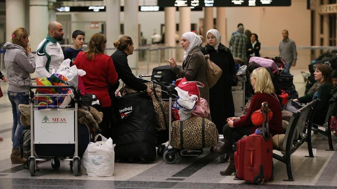 In this Friday, Nov. 20, 2015 file photo, travellers stand next to their luggage at the departure terminal of Rafik Hariri international airport, in Beirut, Lebanon. A Lebanese official said on Friday, Jan. 15, 2016 reports that Beirut International Airport doesn’t meet international safety standards are “exaggerated” but acknowledged that the facility needs improvement. (AP Photo/Hussein Malla, File)