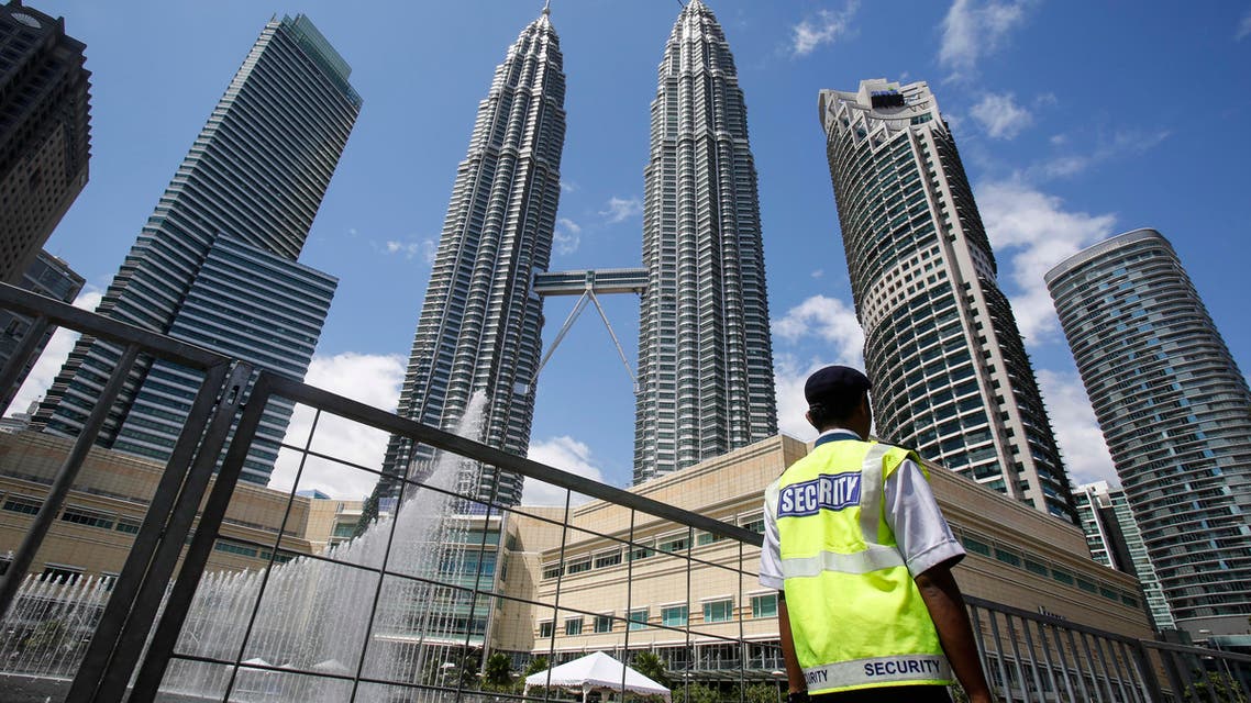 A security guard patrols in front of Malaysia's landmark buildings, Petronas Twin Towers, ahead of the New Year's celebration in Kuala Lumpur, Malaysia, Thursday, Dec. 31, 2015 AP