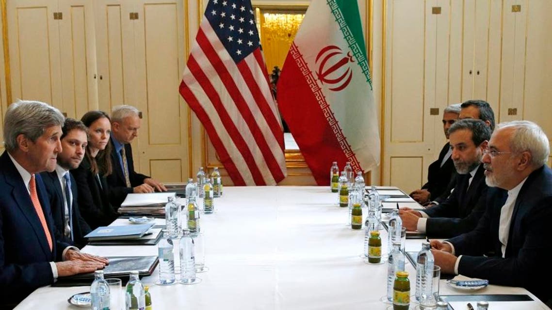 U.S. Secretary of State John Kerry, left, meets with Iranian Foreign Minister Mohammad Javad Zarif, right, in Vienna, Austria, Saturday, Jan. 16, 2016, on what is expected to be "implementation day," the day the International Atomic Energy Agency (IAEA) verifies that Iran has met all conditions under the nuclear deal. (Kevin Lamarque/Pool Photo via AP)