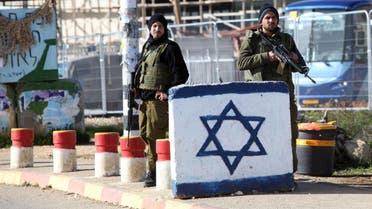 Israeli soldiers stand guard at the Gush Etzion junction in the West Bank following an attack. Tuesday, Jan. 5, 2016. A Palestinian attacker stabbed an Israeli soldier on Tuesday in the West Bank, lightly wounding him before troops at the scene shot and killed the assailant, the military said. (AP Photo/Mahmoud Illean)