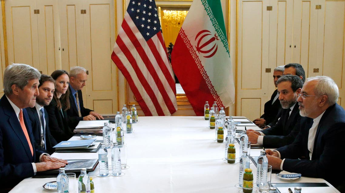 U.S. Secretary of State John Kerry, left, meets with Iranian Foreign Minister Mohammad Javad Zarif, right, in Vienna, Austria, Saturday, Jan. 16, 2016, on what is expected to be "implementation day," the day the International Atomic Energy Agency (IAEA) verifies that Iran has met all conditions under the nuclear deal. (Kevin Lamarque/Pool Photo via AP)