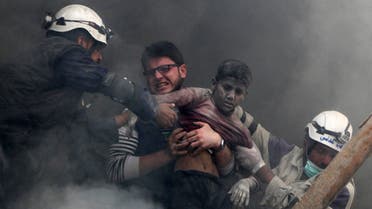 Men rescue a boy from under the rubble after what activists said was explosive barrels dropped by forces loyal to Syria's President Bashar Al-Assad in Al-Shaar neighbourhood of Aleppo April 6, 2014. (Reuters)