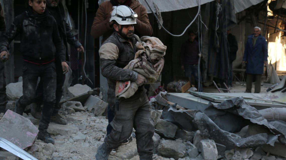 A Syrian Civil Defence worker carries a child wrapped in a blanket over the rubble following a reported air strike by Syrian government forces on the Sukkari neighborhood of Syria's northern city of Aleppo, on January 16, 2016. (AFP)