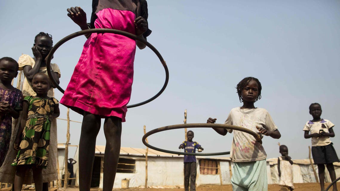 Juba : Children play with hula hoops at the Children Friendly Space, run by UNICEF at the United Nations Missions In South Sudan (UNMISS) Protection of Civillians (PoC) site in Juba, South Sudan, on January 15, 2016. According to UNICEF South Sudan has the highest proportion of out of school children in the world, with more than half (51%) of primary and lower secondary age children do not have access to an education. Even before the 2013 conflict, only one in ten children in South Sudan completed primary school. The country had 1.4 million children out of school. The ensuing two years of violence exacerbat the situation forcing 413,000 more children to drop out of school, leading to the destruction of more than 800 schools. / AFP / Albert Gonzalez Farran