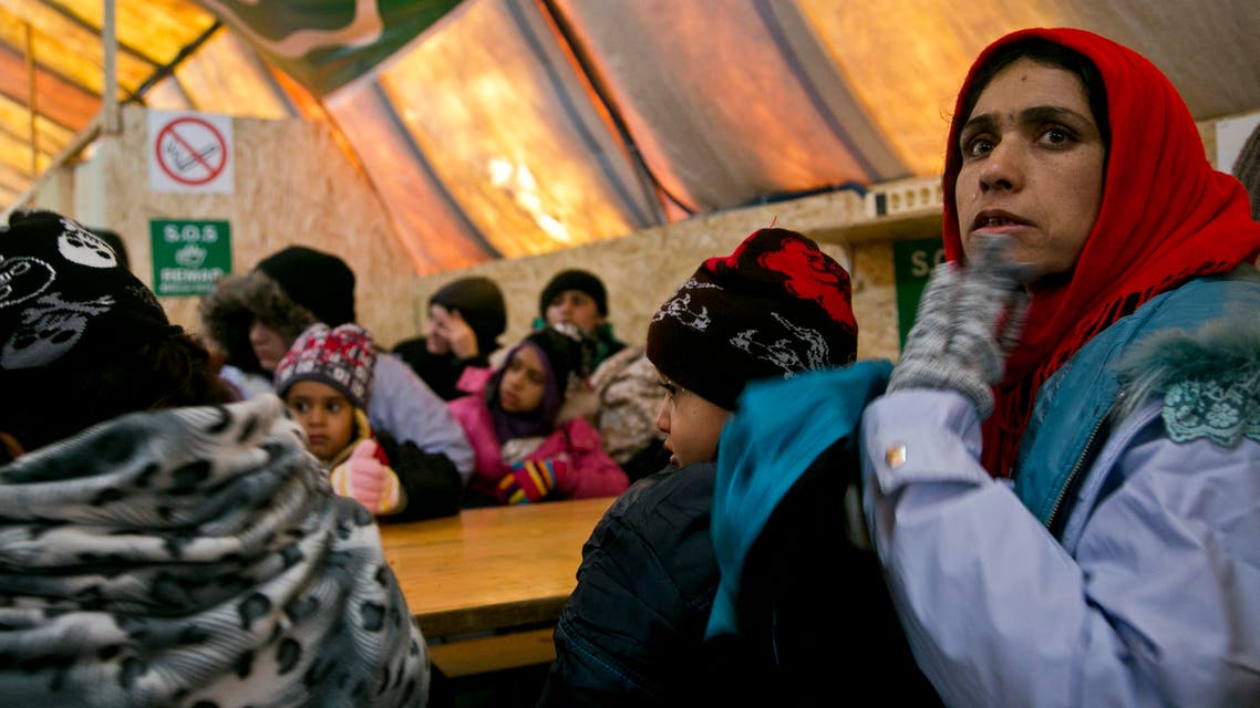 Migrants wait inside a tent to keep warm before departing from the registration camp after crossing from the Macedonian border into Serbia, in Presevo, Serbia, Sunday, Jan. 17, 2016. Despite cold temperatures and snow storms hundreds of migrants continue to arrive daily into Serbia in order to register and continue their journey further north towards Western Europe. (AP Photo/Visar Kryeziu)
