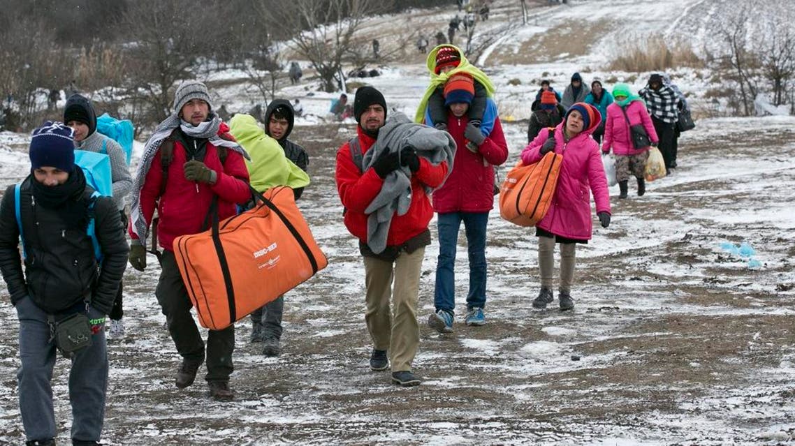 Migrants walk through snow from the Macedonian border into Serbia, near the village of Miratovac, Serbia, Monday, Jan. 18, 2016. Bracing cold temperatures and snow storms hundreds of migrants continue to arrive daily into Serbia in order to register and continue their journey further north towards Western Europe. (AP Photo/Visar Kryeziu)