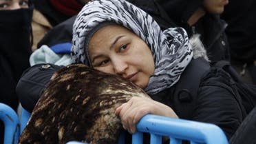 A refugee woman waits to board a train towards Serbia, on her way north to some of the more prosperous European Union countries, from the transit center for refugees near the southern Macedonia's town of Gevgelija, Monday, Jan. 11, 2016. Dozens of Hungary's officers have been sent to Macedonia along with police officers from Serbia and Croatia to help Macedonian colleagues to manage the flow of migrants on its border with Greece. (AP Photo/Boris Grdanoski)