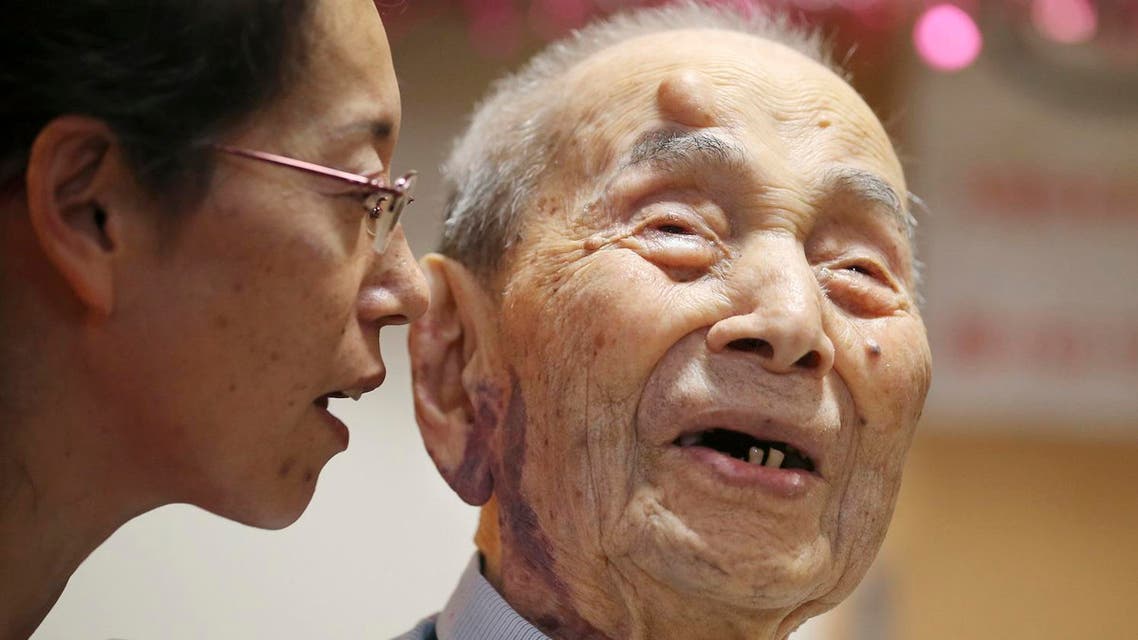 Yasutaro Koide, the 112-year-old living in the central Japanese city of Nagoya, smiles as he talks with his grandchild Aya Kikuchi, 49. (AP)