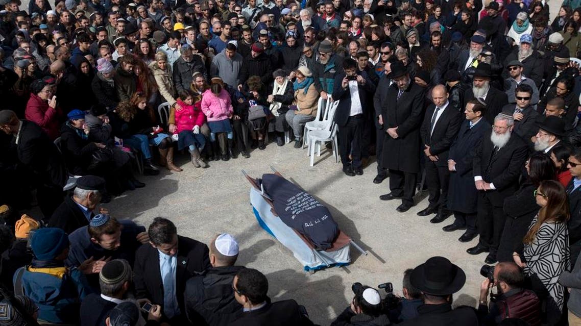 Family and friends of Israeli Dafna Meir attend her funeral in a cemetery in Jerusalem Monday, Jan. 18, 2016. A Palestinian broke into a West Bank settlement home and fatally stabbed an Israeli woman before fleeing Sunday, touching off a massive night manhunt, the Israeli military said. (AP Photo/Sebastian Scheiner)