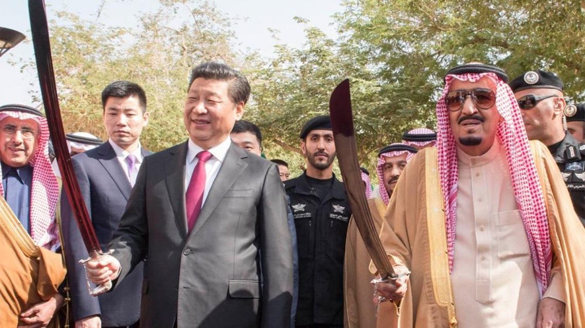 Saudi King Salman with Chinese President Xi Jinping hold a traditional scimitar