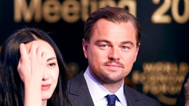 Chinese actress Yao poses with actor DiCaprio after receiving their Crystal Awards during the annual meeting of the WEF in Davos. (Reuters)