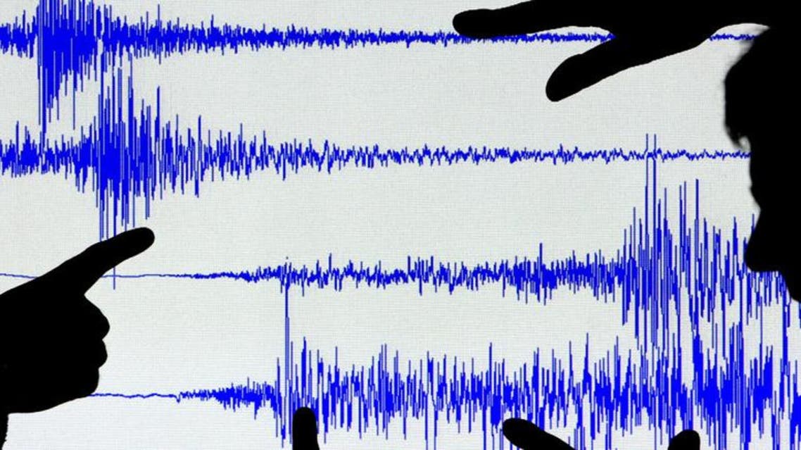 Scientists from the British Geological Survey look at a seismogram readout of Britain's strongest earthquake in twenty years in Edinburgh, Scotland. (Reuters)