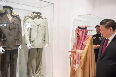 Saudi King Salman with Chinese President Xi Jinping displaying a collection of military uniforms