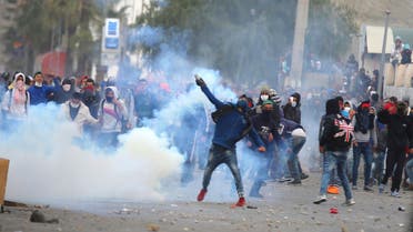 A protester throws a tear gas canister back toward police during a protest outside the local government office in Kasserine, Tunisia January 21, 2016. (Reuters)