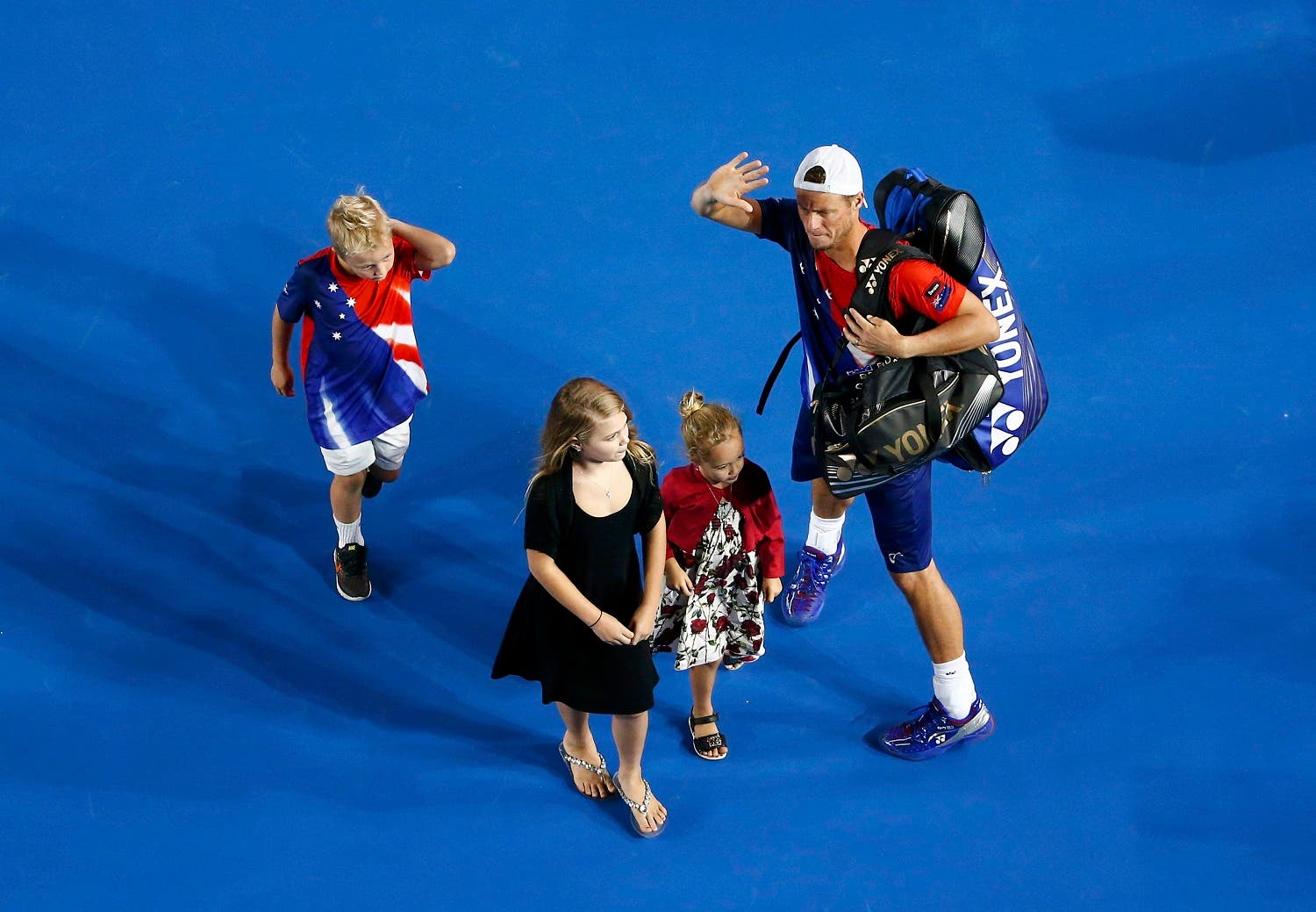 Australia's Lleyton Hewitt leaves with his children after playing his final Australian Open singles match before his retirement. (Reuters)