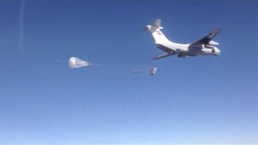 Still image taken from handout video footage shows a Russian air force cargo plane dropping off humanitarian aid in the region around the eastern Syrian city of Deir al-Zor. 9