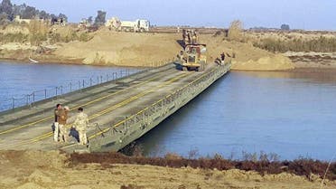  Iraqi army engineers seen building a bridge over the Euphrates River 115 kilometers west of Baghdad, Iraq (File photo AP)