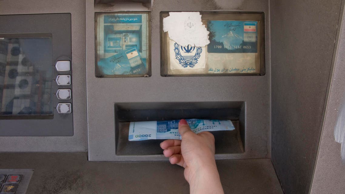 A woman draws money from an ATM machine in Tehran (File photo: Reuters)